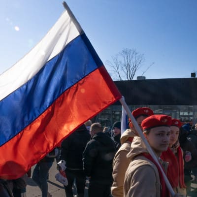 young man with Russian tricolor flag