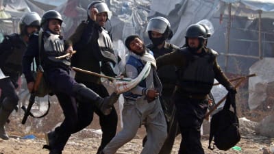 Poliser i Islamabad släpar hårdhänt iväg en demonstrant.