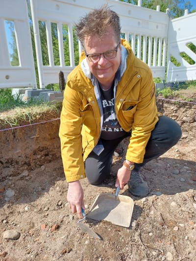 Arkeologen Jan Fast som jobbar med skyffel och spade i en utgrävningsgrop
