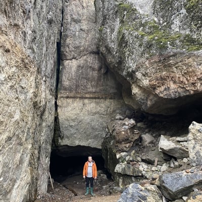 Johan Rikberg vid grottöppning i Gumbostrand i Sibbo. Grottan sägs leda in till Lemminkäinens tempel, som enligt guiden Ior Bock fanns där. . 