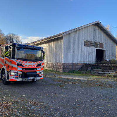 En brandbil framför en byggnad. 