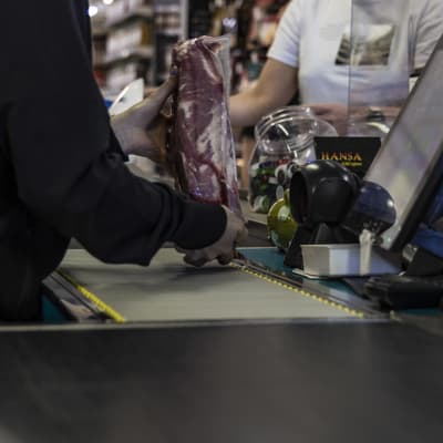 Näätämön Nord 1 Marketin kassalla myyjä tutkailee lihakimpaletta.