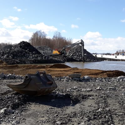 Kaivinkone töissä Pielisjoen rannassa entisen sahan tukkialtaassa.