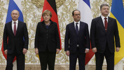 Tre herrar och en dam förhandlar om en lösning på Ukrainakrisen.