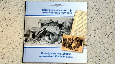 En bok som visar ett sönderbombat hus i Lojo.