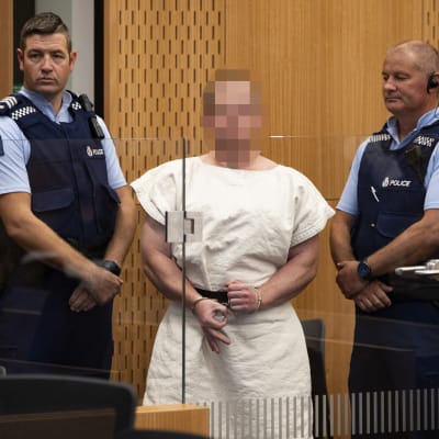 Den 28-årige australiern som åtalas för 51 mord och 40 mordförsök förnekade all skuld i då han deltog i domstolsbehandlingen vida videolänk 