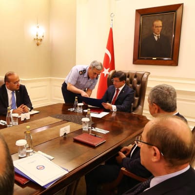 Chefen för det turkiska flygvapnet Akin Ozturk talar med Turkiets premiärminister Ahmet Davutoglu.