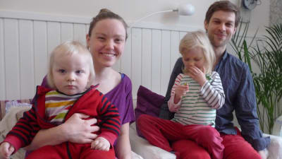 Familjen Lindström-Lindqvist i en soffa. På bild finns föräldrarna Victoria och Jon samt två barn i ålder ett till fyra år.