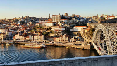 Kvällssolen lyser över floden Douros norra sida av staden Porto.