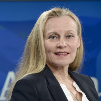 Maria Löfgren i halvbild mot blå bakgrund
