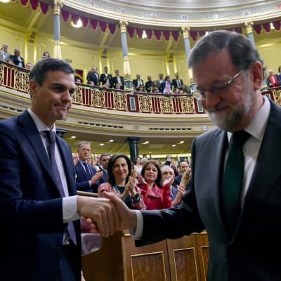 Spaniens avgående premiärminister Mariano Rajoy skakar hand med den nya premiärminister Pedro Sanchez.