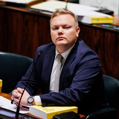 Antti Kurvinen sittande på sin plats i riksdagens plenisal. 