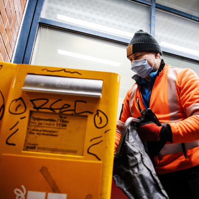 Postinkuljettaja tyhjensi postilaatikon Korsossa 14. joulukuuta 2020 klo 17 aikaan.