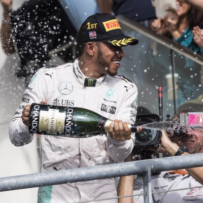 Lewis Hamilton sprutar champagne på podiet den 23 augusti 2016.