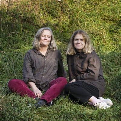 Annika Luther och Herta Donner sitter i gräset