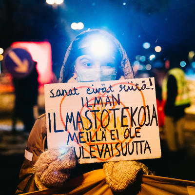Mielenosoittaja pitelee kylttiä