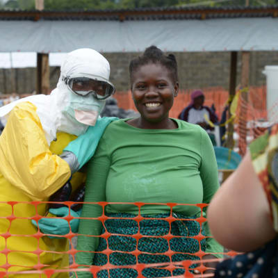 En läkre från franska Läkare utan gränser poserar med en patient innanför ett högsriskområde i Liberias huvudstad Monrovia.