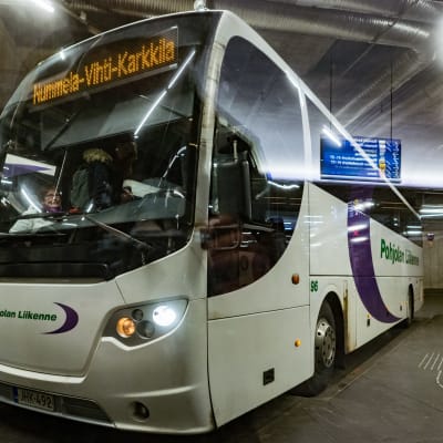 Pohjolan Liikennes buss står parkerad vid en hållplats i Kampen i Helsingfors. 