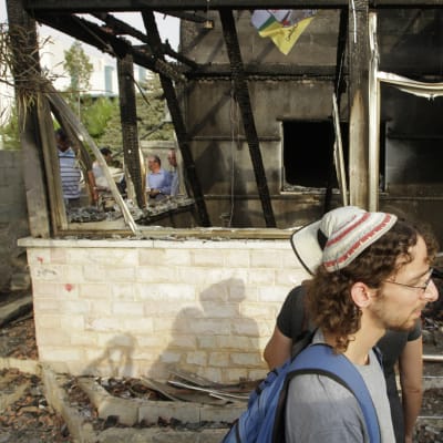 Israeliska fredsaktivister utanför huset till familjen som utsattes för en brandbombsattack  i juli 2015.