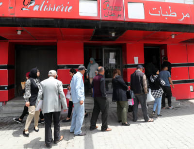 Tunisier står i kö vid ett bageri som producerar subventionerat bröd.
