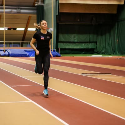 Pituushyppääjä Taika Koilahti harjoittelee ja juokseen Kupittaan urheiluhallissa.
