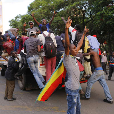 Folk på gatornai Herare firar Mugabes avgång.