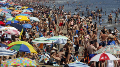 turister på strand i Spanien