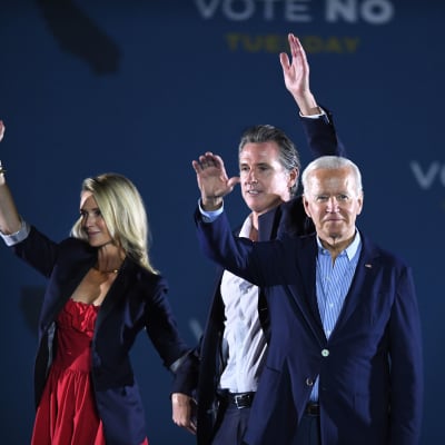 Kuvernööri Gavin Newsome vaimonsa Jennifer Siebel Newsomin sekä presidentti Joe Bidenin kanssa kampanjatilaisuudessa maanantaina Long Beachissä.