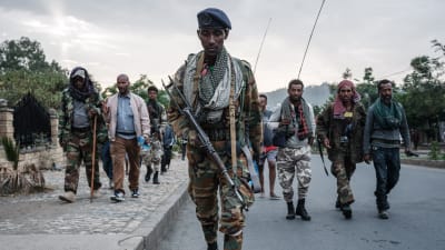 Soldater i utrustning går på en gata i Etiopien. De tillhör Tigrayrebellerna.