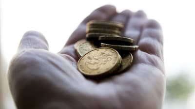 Euromynt i en öppen handflata.