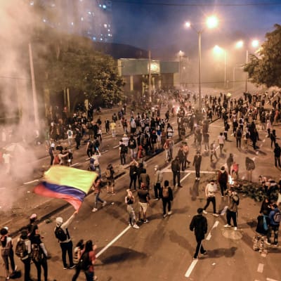 Unga människor samlade på gatan för att protestera i Colombia.