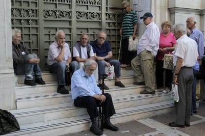 Grekiska pensionärer utanför en bankautomat i Aten.