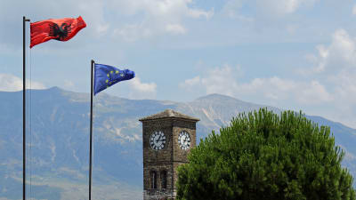 EU-flaggan och Albaniens flagga på fästningen i Gjirokaster i Albanien.