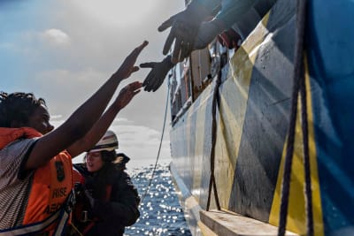 Mission Lifelines bild på hur en migrant stiger ombord på fartyget Rise Above