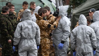 Brittisk militär klädde på sig skyddsdräkter på söndagen då de förberedde sig för att flytta bort bilar från en parkering i Salisbury. 