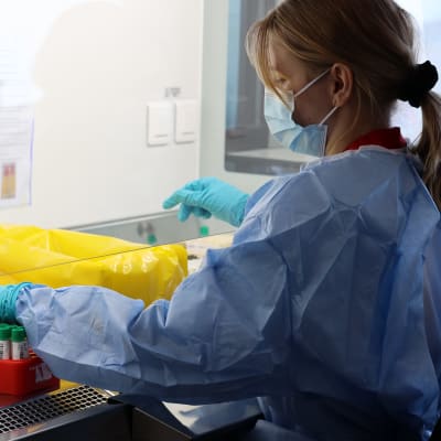 En skyddsklädd person undersöker prover i laboratoriet Vita Lab