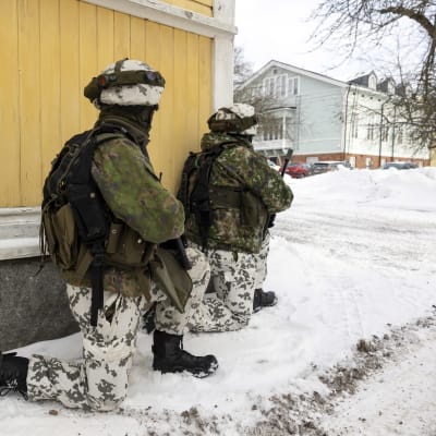 Reserviläisiä rakennuksen kulmalla. 