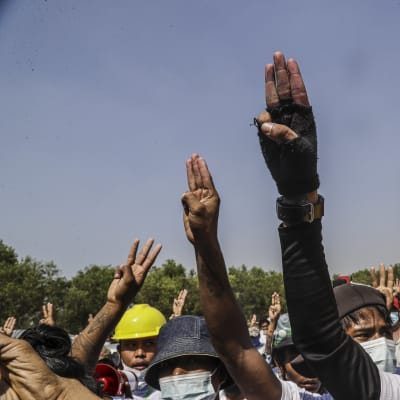 Tre finger hälsningen har blivit demokratiaktivisternas symbol i Myanmar. Bilden visar en grupp demonstranter vid begravningen av två ledande oppositionsaktivister i Rangoon.