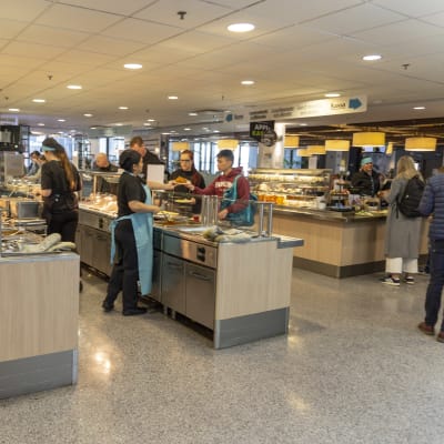 Kunder som plockar åt sig lunch vid UniCafes studentrestaurang. 