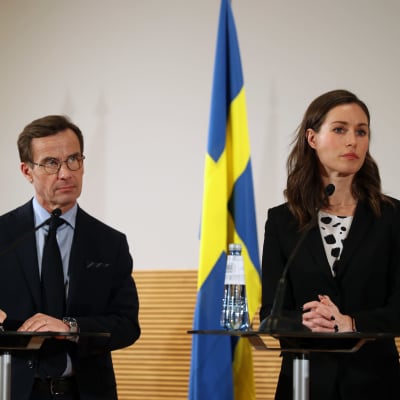 Ulf Kristersson och Sanna Marin står bredvid varandra vid varsitt talarpodium.