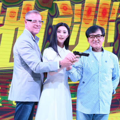 Renny Harlin står bredvid Fan Bingbing, som håller i en pistol tillsammans med Jackie Chan (t.h.)