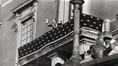 Carl XVI Gustaf vinkar från slottsbalkongen efter att han blivit kung år 1973.