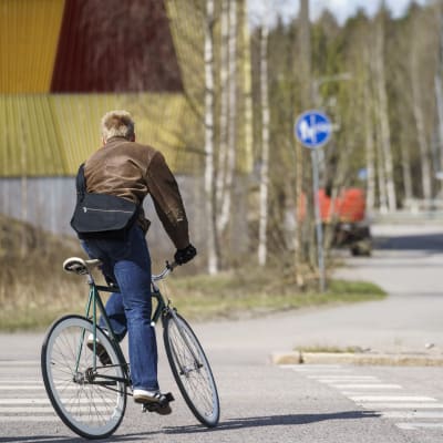Pyöräilijä ajaa suojatiellä.