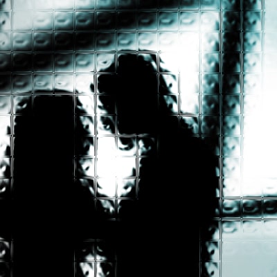 siluetten av man och kvinna bakom glasruta