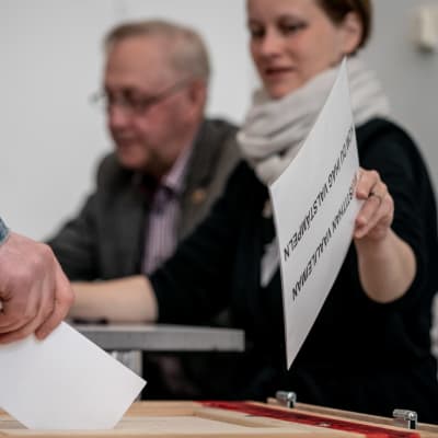 En väljare sätter sin röst i valurnan.