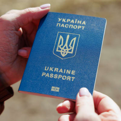 Lähikuva Ukrainan passista naisen käsissä.