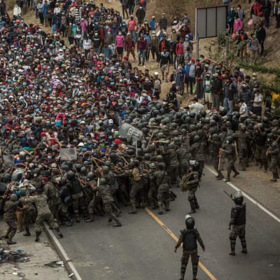 Guatemalanska soldater tog till käppar, batonger och tårgas för att tvinga tillbaka honduranska migranter vid en vägspärr i staden Chiquimuta på söndagen. 
