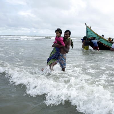 Flyktingar från Burma anländer till Bangladesh vid stranden av floden Naf.