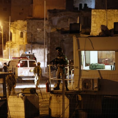 Israelisk militär bevakar platsen där en ung kvinna dödades i Hebron 14.2.2016.