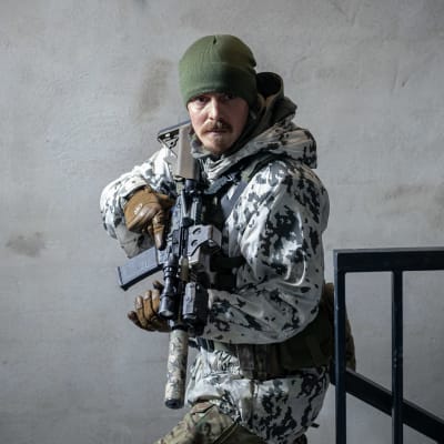 Jasper Pääkkönen Omerta-elokuvassa seisoo kivääri kädessä maastopuvussa.